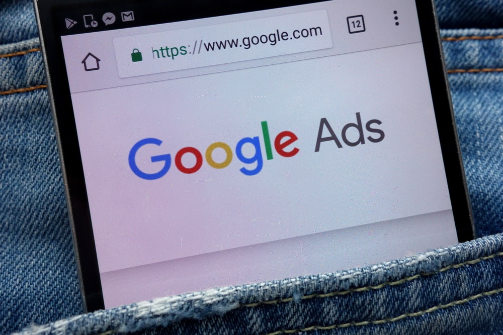 Phone with Google Ads displayed in jeans pocket