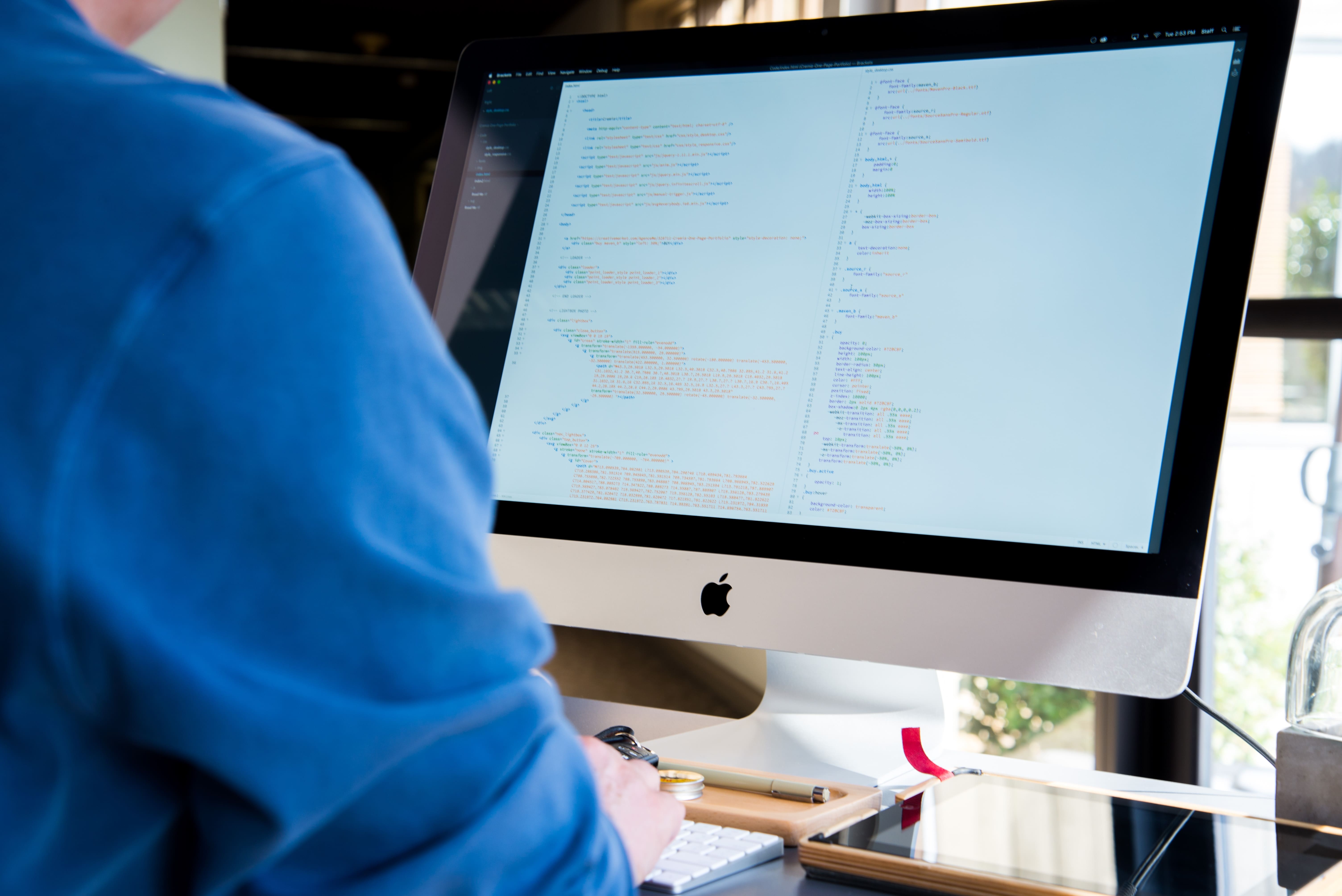 web designer working on a Mac computer